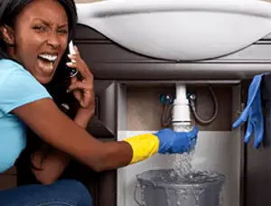 Emergency plumbing repair for a leaking sink drain under a bathroom vanity in Evansville, IN